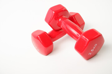 Sport equipment. Two red dumbbells for fitness weighing 2 kg on a white background.