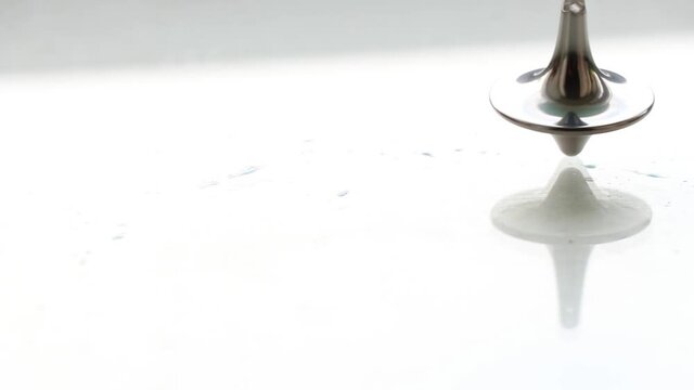 zinc gyroscope spinning on isolated glass background, video for meditation