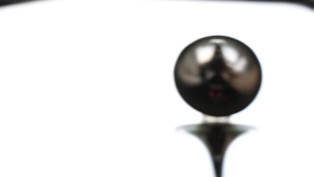 zinc gyroscope spinning on isolated glass background, video for meditation