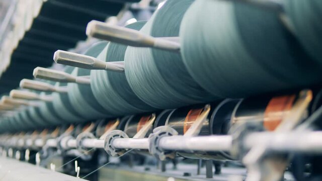 Sewing spools managed by a factory machine in a close up