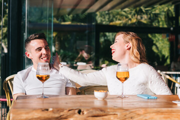 Friends drinking a beer while having a meeting with friends at the bar or restaurant.