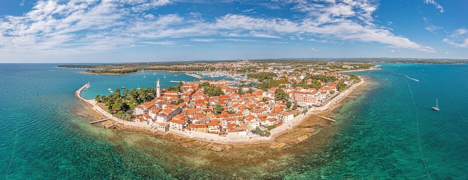 Drone panorama over the Croatian coastal town Novigrad with harbor and promenade taken from the sea side during the day