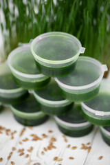 Frosted jars with wetgrass on the background of wheat germ.
