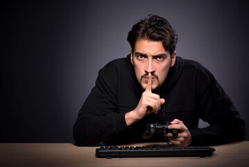 Young male gamer on grey background