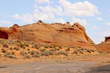 Fototapeta na wymiar Smooth Rock Formation Protruding From High Desert