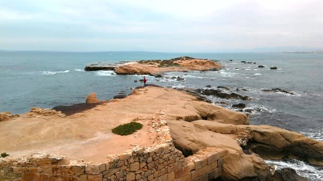 Strut of the Island of Tabarca towards the sea at one end and with a person walking. Alicante 