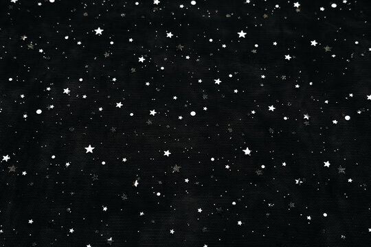 Festive christmas new year black night fabric tulle, background with silver glitter star. Christmas dark backdrop with shine star sequin