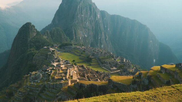 Machu Picchu citadel illuminated by the morning sun, a beautiful view of the Inca settlement. View from the top. No people.