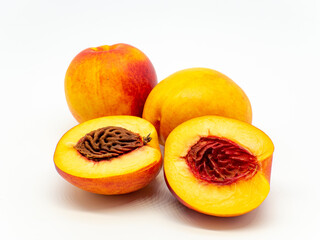 sliced and whole nectarines heap on white background