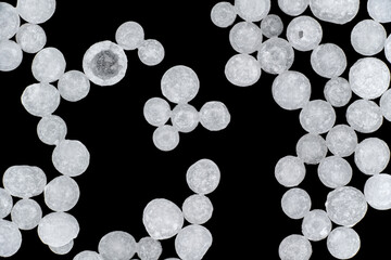 Sodium Hydroxide beads or lye - closeup detail to white granules, image width 19mm