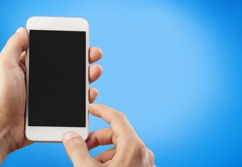 Male hand holding a smartphone with a blank screen