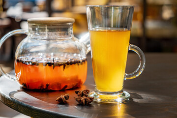 ..Organic hot tea with lemon and herbs in cup.