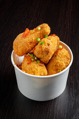 Portion of fried chicken nuggets with fresh vegetables