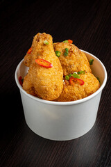 Portion of fried chicken nuggets with fresh vegetables