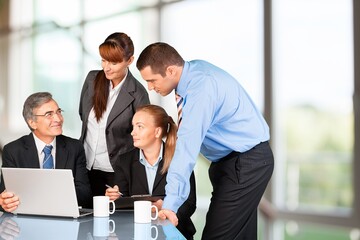 Happy motivated business leader talking to team, meeting with employees, managers.