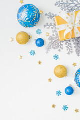 Flat lay frame with christmas balls and gift box on a white background. Merry christmas card and copy space for your text