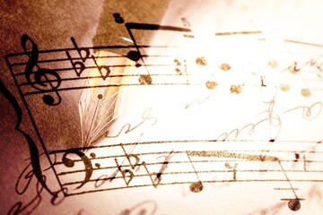 writing musical notes on sheet with quill pen and ink. music concept