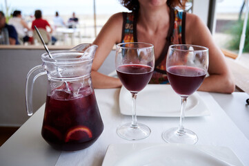 Pitcher of sangria with two glasses on a beach terrace