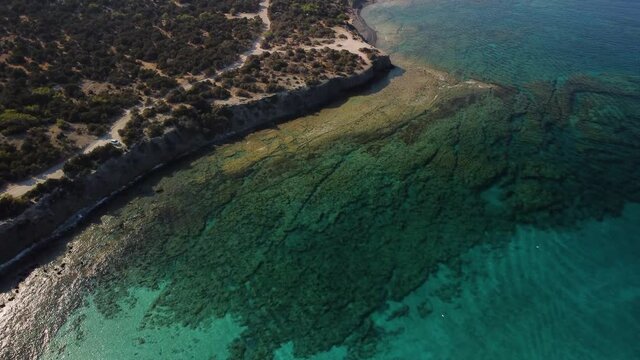 Aerial drone view of the rocky coast and the Mediterranean Sea near the scenic Aphrodite Trail in the Akamas Peninsula National Park, Cyprus. Famous tourist travel destination near Polis city,