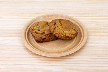 Fluffy cookies with dark chocolate chips on cardboard plate