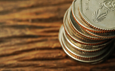 coins stacked on each other in different positions on the wooden floor.