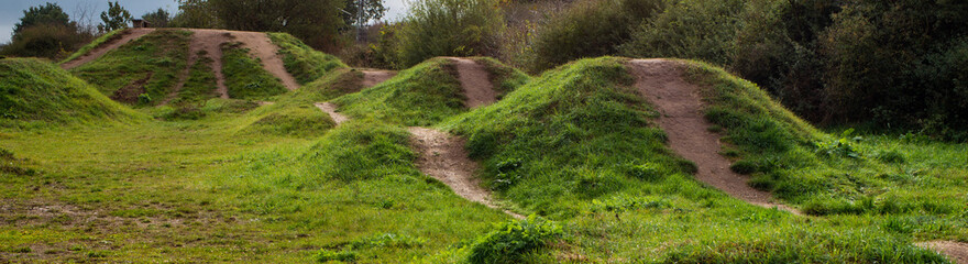 A bike park with small trails, jumps and hills