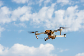 Drone fllying over blue sky.
