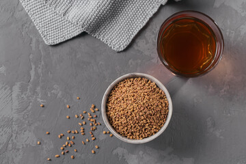 Bowl of fenugreek seeds and Egyptian fenugreek yellow tea or Methi Dana drink