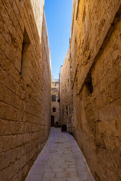 Malta, Mdina, Narrow cobbled street and medieval stone walls in old capital - Silent City