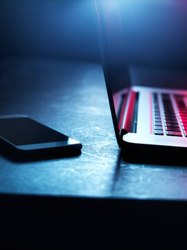 Laptop and smartphone at night