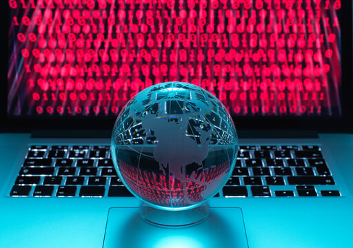 Globe illustrating the Americas on a laptop computer with screen been infected by a cyber attack