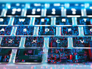 Double exposure of a laptop computer showing electronic components under the keyboard