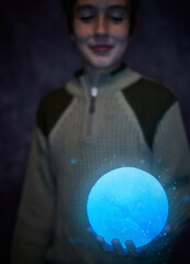 Cute boy holding the little shiny Moon