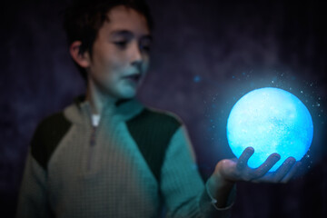 Cute boy holding the little shiny Moon