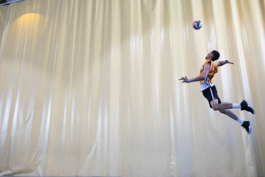 Man jumping during a volleyball match to start a game