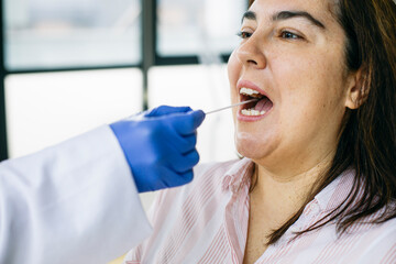 Close-up of taking a swab from the patient's mouth