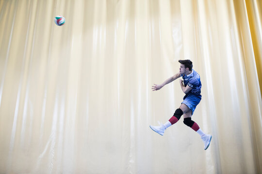 Man jumping during a volleyball match to start a game