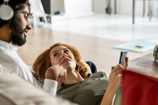 Couple relaxing on couch, planning their road trip