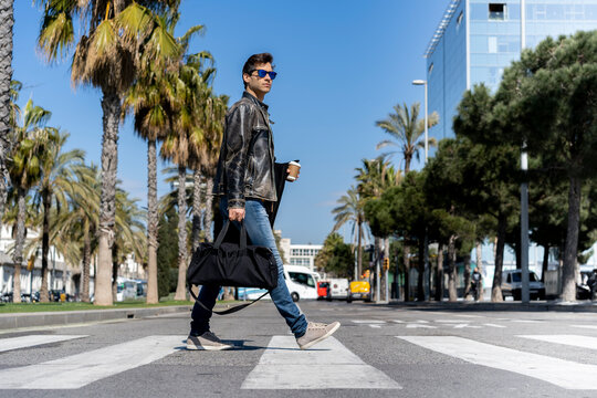 Spain, Barcelona, man in the city crossing the street