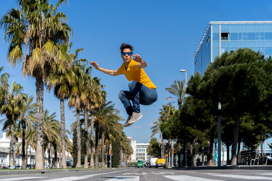 Spain, Barcelona, man in the city jumping on the street