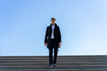 Businessman walking down stairs