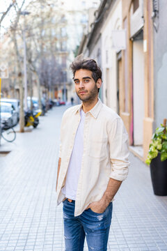 Portrait of a man standing on pavement