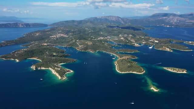 Aerial drone panoramic video of natural fjord bay of Meganisi or Meganissi island a safe anchorage for sail boats featuring crystal clear turquoise beaches, Ionian, Greece