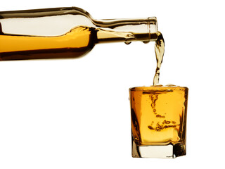 Whiskey from the bottle is poured into a glass with bubbles and drops. Isolated on a white...