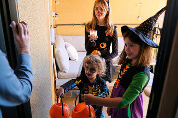 Kids get excited about trick-or-treating at the Halloween party.