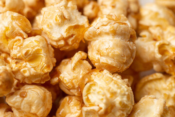 A lots of caramelized popcorn as a textured background for food advertising