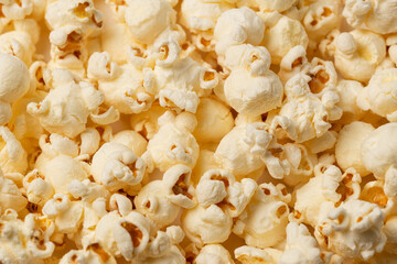 A lots of salted popcorn as a textured background for food advertising