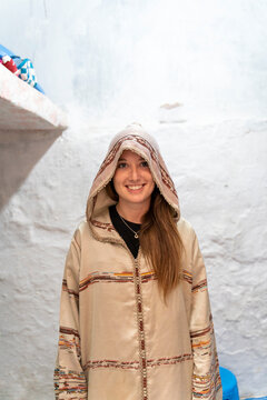 Portrait of smiling young woamn wearing Djellaba, Fez, Morocco