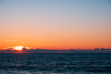 Fototapeta na wymiar the sky during sunset at sea. clouds on the horizon