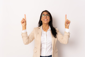 Photo of happy businesswoman wearing eyeglasses smiling and standing pointing fingers up isolated over white background